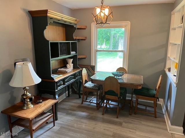 5559 Fitch Rd, North Olmsted, OH 44070 - dining area featuring a chandelier and light wood-style floors