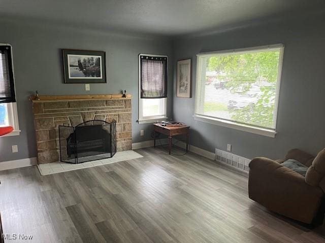 5559 Fitch Rd, North Olmsted, OH 44070 - living room featuring healthy amount of natural light, a fireplace, and wood finished floors