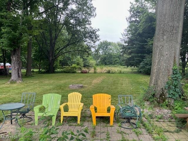 5559 Fitch Rd, North Olmsted, OH 44070 - view of green lawn with a fire pit and a patio area