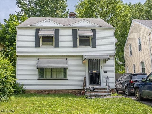 931 Yellowstone Rd, Cleveland, OH 44121 - view of front of house with a front yard, entry steps, a chimney, and roof with shingles