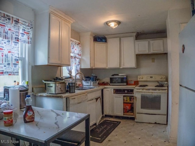 931 Yellowstone Rd, Cleveland, OH 44121 - kitchen with white appliances, light countertops, and light flooring