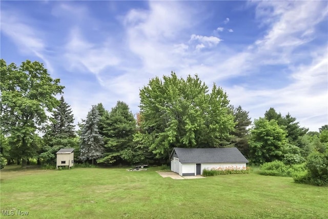 3781 Main St, Perry, OH 44081 - view of green lawn with an outdoor structure and a detached garage
