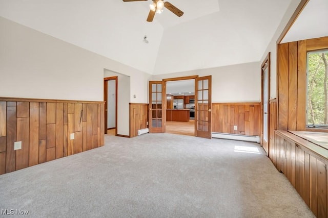 38038 Ridge Rd, Willoughby, OH 44094 - spare room with baseboard heating, a wainscoted wall, light carpet, wooden walls, and french doors