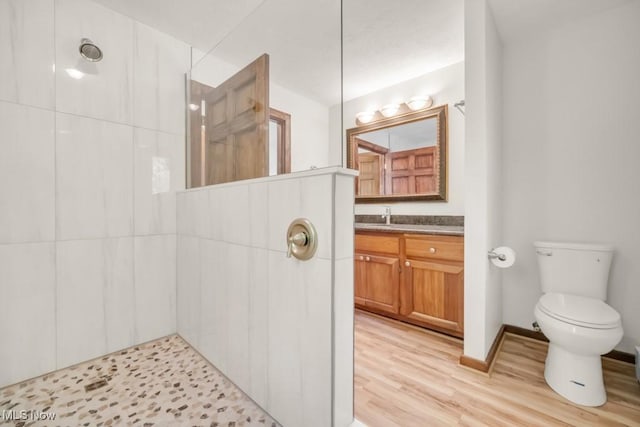 38038 Ridge Rd, Willoughby, OH 44094 - full bathroom featuring a tile shower, vanity, and wood finished floors