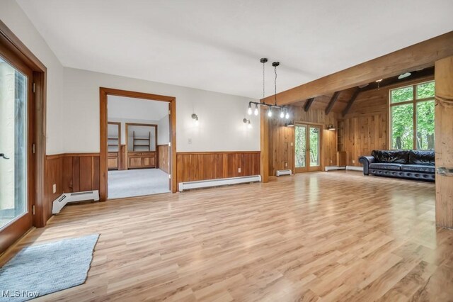 38038 Ridge Rd, Willoughby, OH 44094 - unfurnished living room with a baseboard radiator, wood walls, light wood-style flooring, and a wainscoted wall