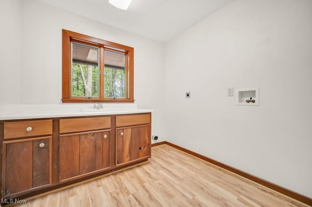 38038 Ridge Rd, Willoughby, OH 44094 - laundry room featuring hookup for an electric dryer, washer hookup, light wood-type flooring, and cabinet space