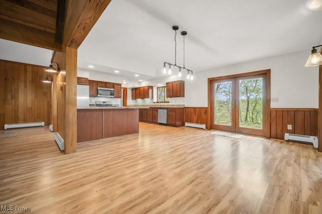 38038 Ridge Rd, Willoughby, OH 44094 - kitchen featuring appliances with stainless steel finishes, a baseboard radiator, light wood-style flooring, wainscoting, and brown cabinets