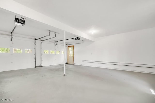 38038 Ridge Rd, Willoughby, OH 44094 - garage featuring baseboard heating and a garage door opener