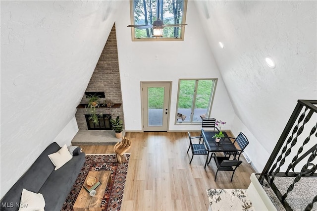 2269 N Fox N Rd, Hubbard, OH 44425 - living room featuring wood finished floors, high vaulted ceiling, and a brick fireplace
