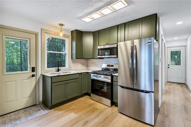 2269 N Fox N Rd, Hubbard, OH 44425 - kitchen with green cabinets, stainless steel appliances, light wood-type flooring, decorative backsplash, and recessed lighting