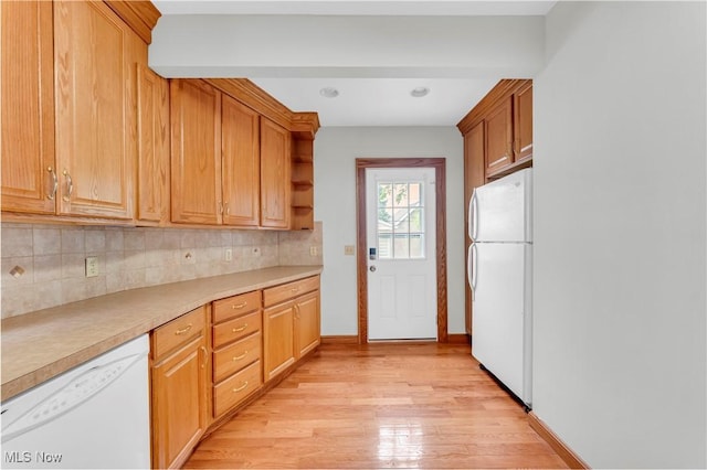 1716 Ardoyne Ave, Cleveland, OH 44109 - kitchen featuring white appliances, tasteful backsplash, light wood finished floors, and light countertops