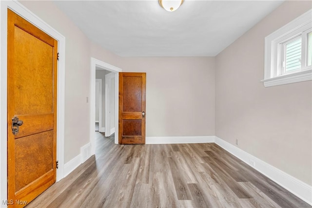 1716 Ardoyne Ave, Cleveland, OH 44109 - spare room with wood finished floors and baseboards