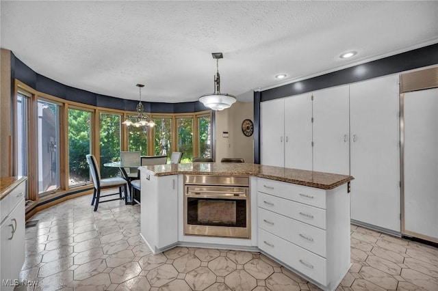 6869 Cliffside Dr, Vermilion, OH 44089 - kitchen featuring oven, a textured ceiling, fridge, white cabinets, and recessed lighting