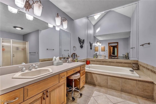 6869 Cliffside Dr, Vermilion, OH 44089 - bathroom featuring tile patterned floors, vaulted ceiling, vanity, a garden tub, and a shower stall