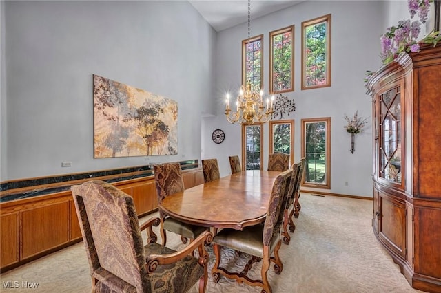 6869 Cliffside Dr, Vermilion, OH 44089 - dining area featuring a towering ceiling, a chandelier, and light carpet