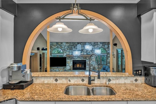 6869 Cliffside Dr, Vermilion, OH 44089 - kitchen with light stone countertops and a fireplace