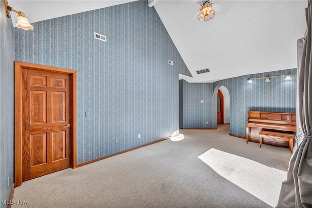6869 Cliffside Dr, Vermilion, OH 44089 - unfurnished living room featuring arched walkways, vaulted ceiling, and carpet
