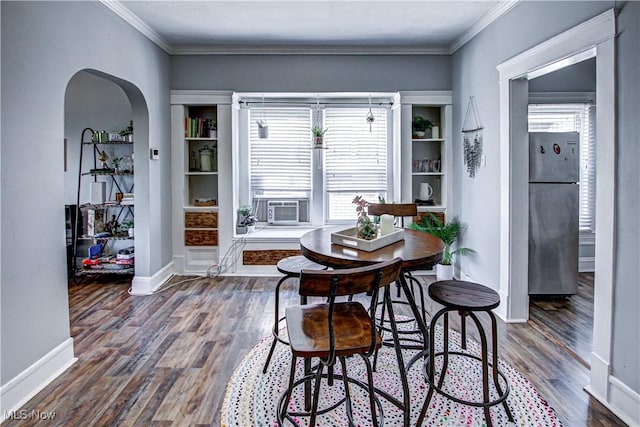 1289 W 115th St, Cleveland, OH 44102 - dining space featuring arched walkways, dark wood-style floors, cooling unit, and crown molding