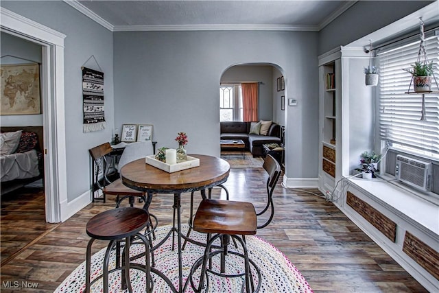 1289 W 115th St, Cleveland, OH 44102 - dining space featuring arched walkways, wood finished floors, ornamental molding, and cooling unit