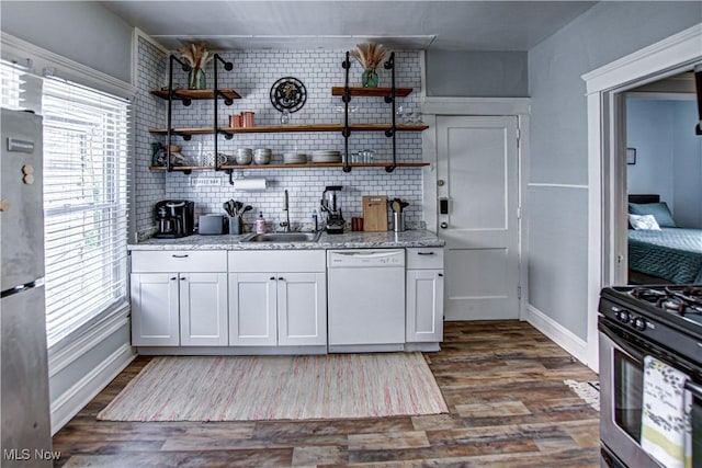 1289 W 115th St, Cleveland, OH 44102 - kitchen with white dishwasher, gas range oven, freestanding refrigerator, and healthy amount of natural light