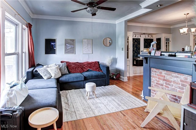 1289 W 115th St, Cleveland, OH 44102 - living area featuring wood finished floors, a ceiling fan, crown molding, and a chandelier