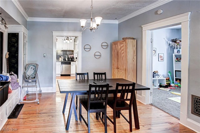 1289 W 115th St, Cleveland, OH 44102 - dining room with a chandelier, light wood-style floors, and crown molding