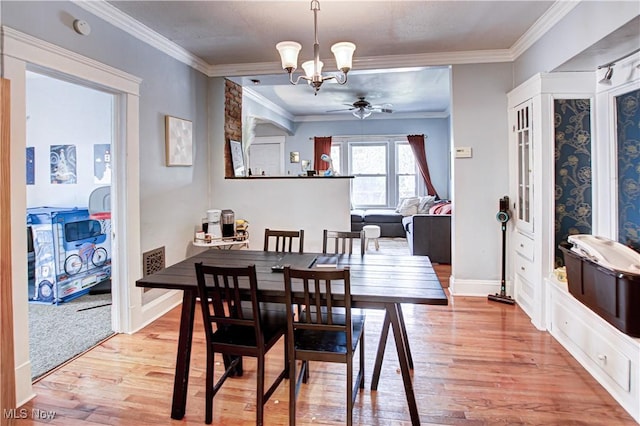 1289 W 115th St, Cleveland, OH 44102 - dining area with ceiling fan, light wood-style flooring, crown molding, and a chandelier