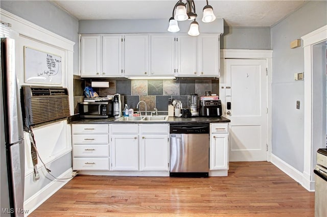 1289 W 115th St, Cleveland, OH 44102 - kitchen with appliances with stainless steel finishes, white cabinets, dark countertops, and decorative backsplash