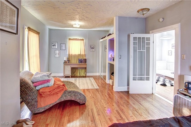 1289 W 115th St, Cleveland, OH 44102 - living area with a textured ceiling, wood finished floors, and plenty of natural light