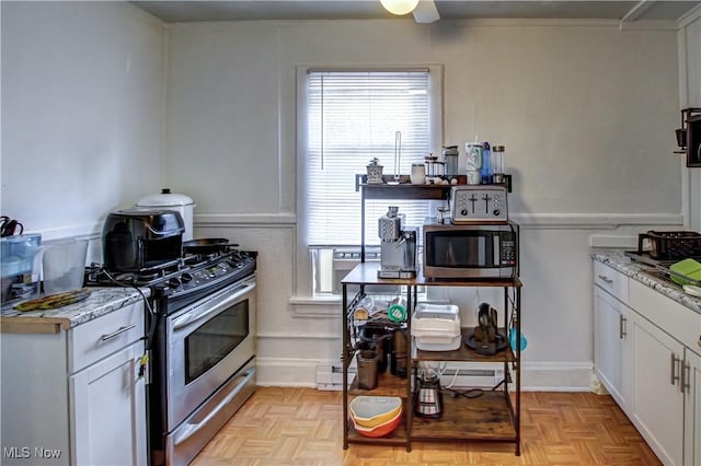 1289 W 115th St, Cleveland, OH 44102 - kitchen with stainless steel appliances, healthy amount of natural light, white cabinetry, and light stone counters