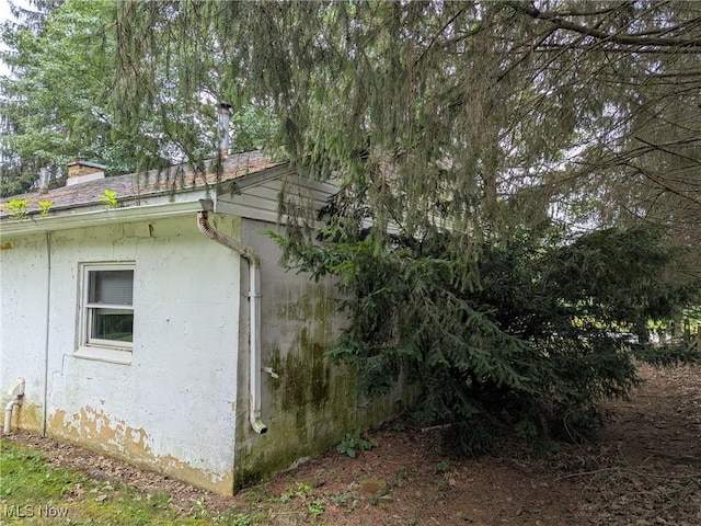 4562 Erie Ave NW, Canal Fulton, OH 44614 - view of home's exterior featuring stucco siding and a chimney