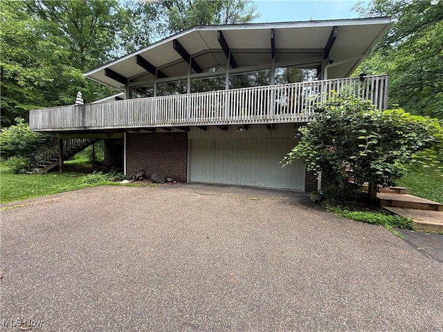 126 Stony Creek Dr, Millersburg, OH 44654 - view of front of property featuring stairway, a wooden deck, and asphalt driveway