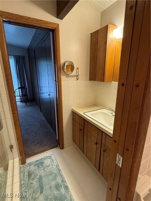 126 Stony Creek Dr, Millersburg, OH 44654 - full bathroom featuring vanity, tile walls, and tile patterned floors