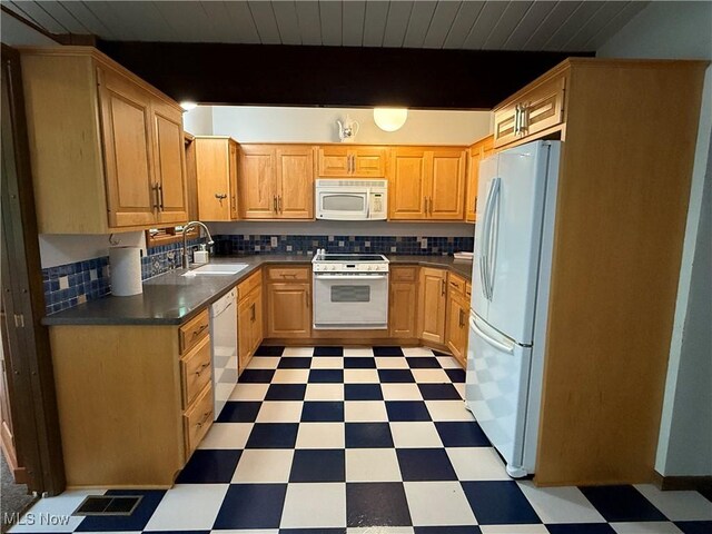 126 Stony Creek Dr, Millersburg, OH 44654 - kitchen with white appliances, light floors, backsplash, dark countertops, and a wood ceiling with exposed beams