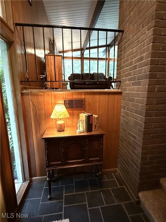 126 Stony Creek Dr, Millersburg, OH 44654 - bathroom with brick wall, wood walls, and stone finish flooring