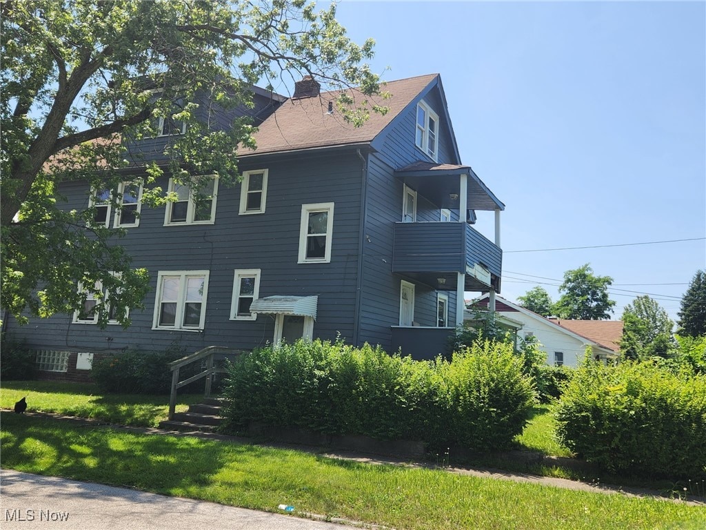 12813 Gay Ave, Cleveland, OH 44105 - view of side of home with a chimney and a yard