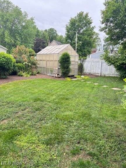 202 N Ray St, Baltic, OH 43804 - view of yard featuring a greenhouse and an outbuilding