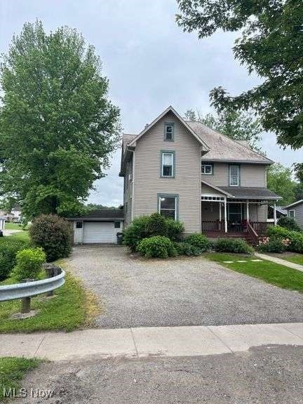 202 N Ray St, Baltic, OH 43804 - view of front of house featuring covered porch and a detached garage