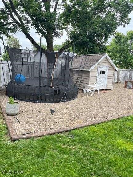 202 N Ray St, Baltic, OH 43804 - view of yard featuring a trampoline and a storage shed