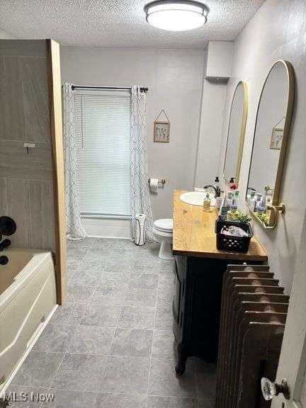 202 N Ray St, Baltic, OH 43804 - full bath with vanity, a textured ceiling, and shower / tub combination