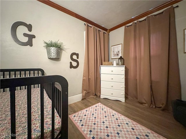 220 N Cleveland Ave, Niles, OH 44446 - bedroom featuring wood finished floors, ornamental molding, and a crib