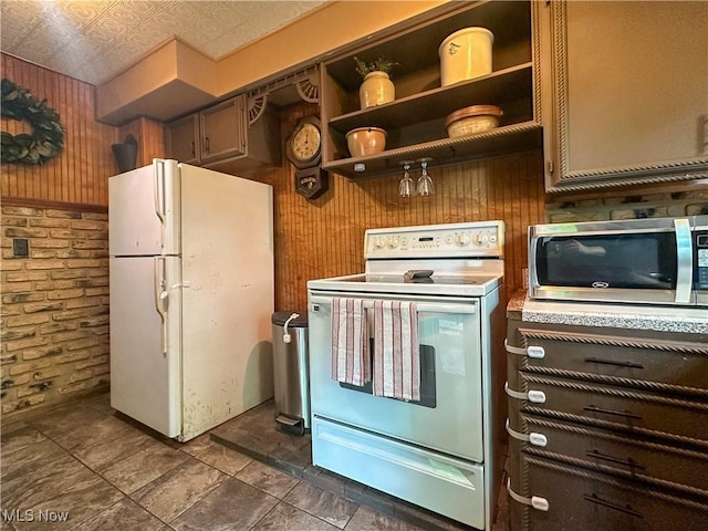220 N Cleveland Ave, Niles, OH 44446 - kitchen featuring white appliances, brick wall, wood walls, and open shelves