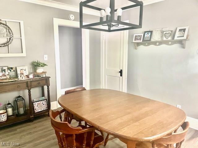 127 William St, Struthers, OH 44471 - dining area with wood finished floors, ornamental molding, and a chandelier