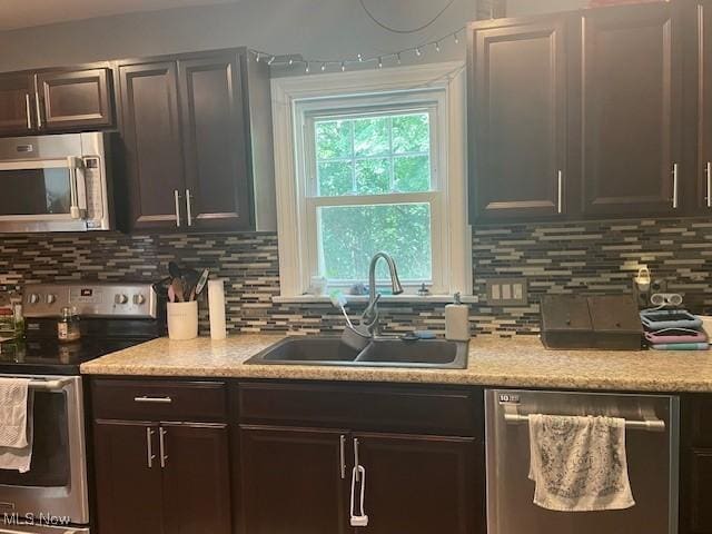 127 William St, Struthers, OH 44471 - kitchen featuring appliances with stainless steel finishes, backsplash, and dark brown cabinetry