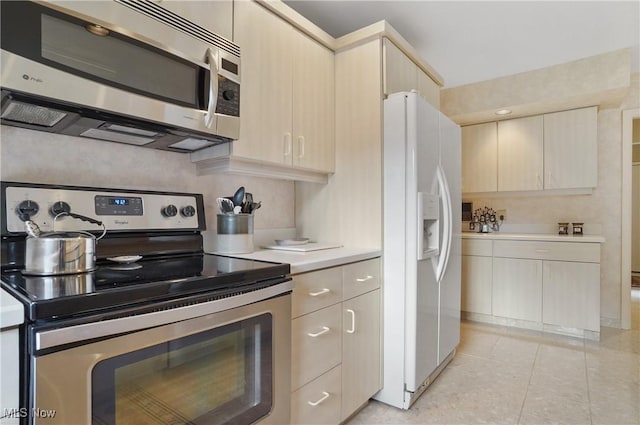 680-7 Windward Dr, Aurora, OH 44202 - kitchen with appliances with stainless steel finishes, light countertops, light brown cabinets, and light tile patterned floors