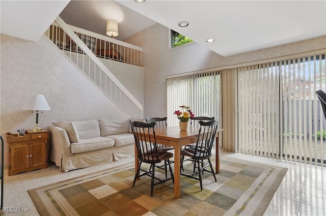 680-7 Windward Dr, Aurora, OH 44202 - dining area with healthy amount of natural light, stairs, a towering ceiling, light tile patterned flooring, and recessed lighting