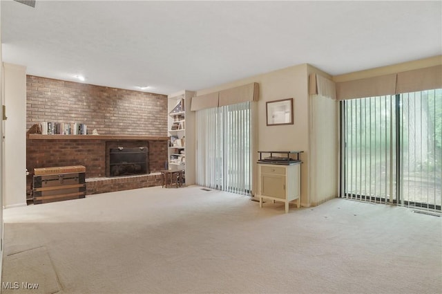 680-7 Windward Dr, Aurora, OH 44202 - unfurnished living room featuring a brick fireplace, carpet floors, and built in features