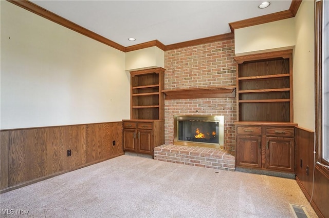 3773 N Shore Dr, Akron, OH 44333 - unfurnished living room with crown molding, wainscoting, a fireplace, wooden walls, and recessed lighting