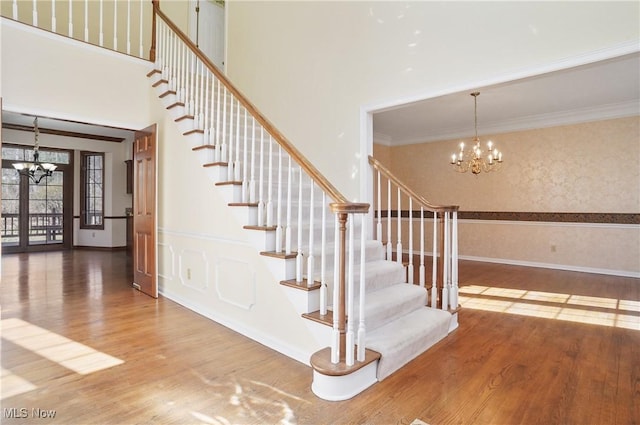 3773 N Shore Dr, Akron, OH 44333 - stairs with a chandelier, wood finished floors, ornamental molding, and a high ceiling