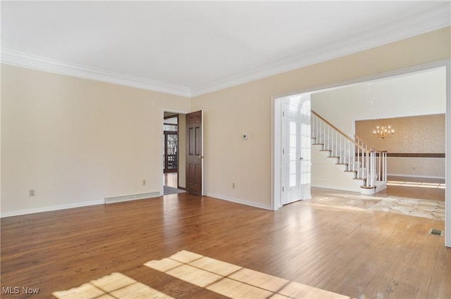 3773 N Shore Dr, Akron, OH 44333 - spare room featuring a chandelier, stairway, ornamental molding, wood finished floors, and healthy amount of natural light